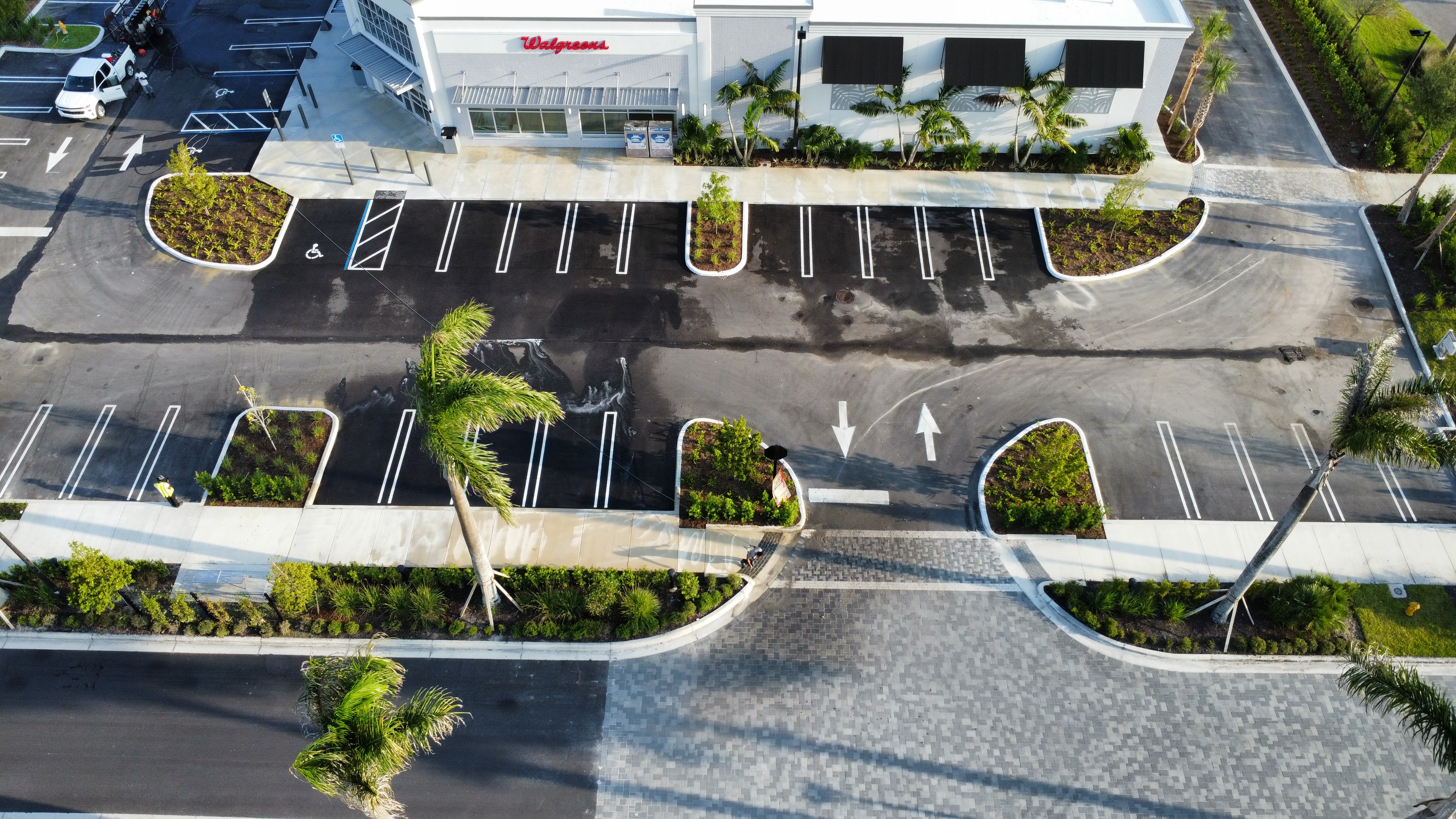 Freshly cleaned commercial retail parking lot and Walgreens storefront after post-construction pressure washing in Central Florida
